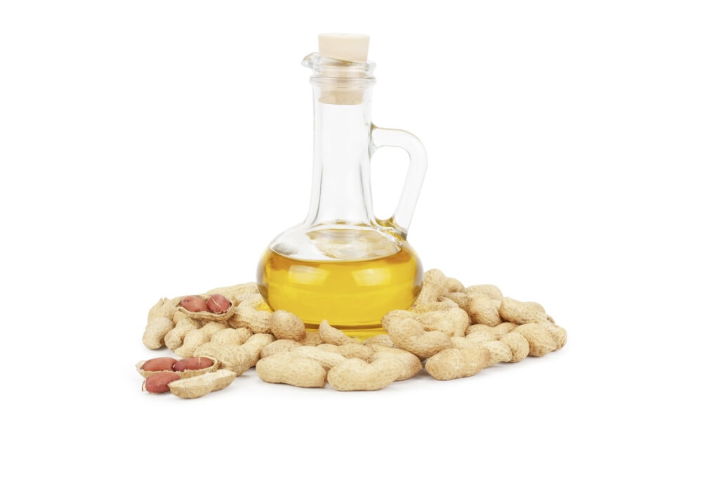 Erdnussöl in Flasche mit Erdnüssen