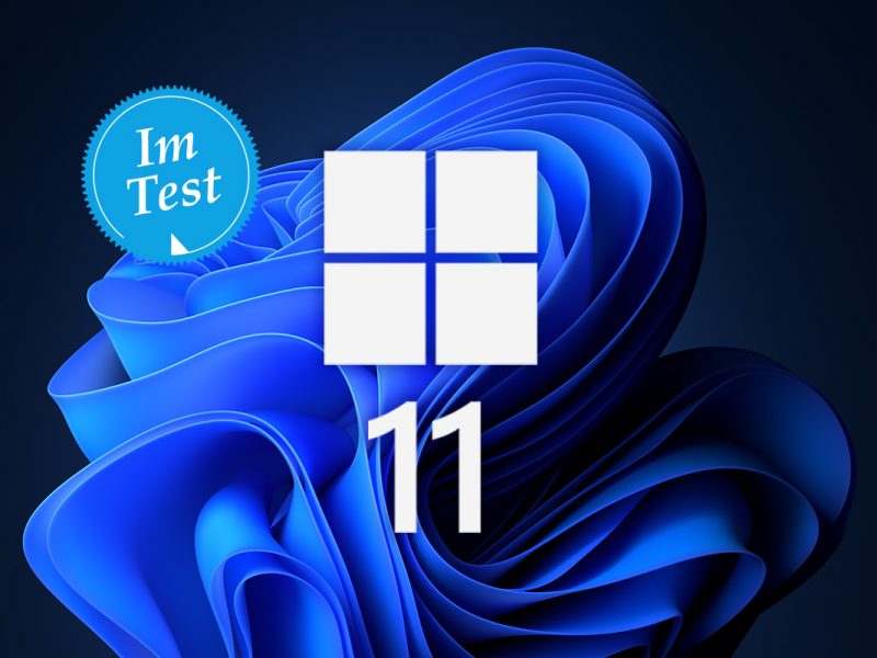 blaue Form auf schwarzem Hintergrund in der Mitte Windows Logo und die Zahl 11
