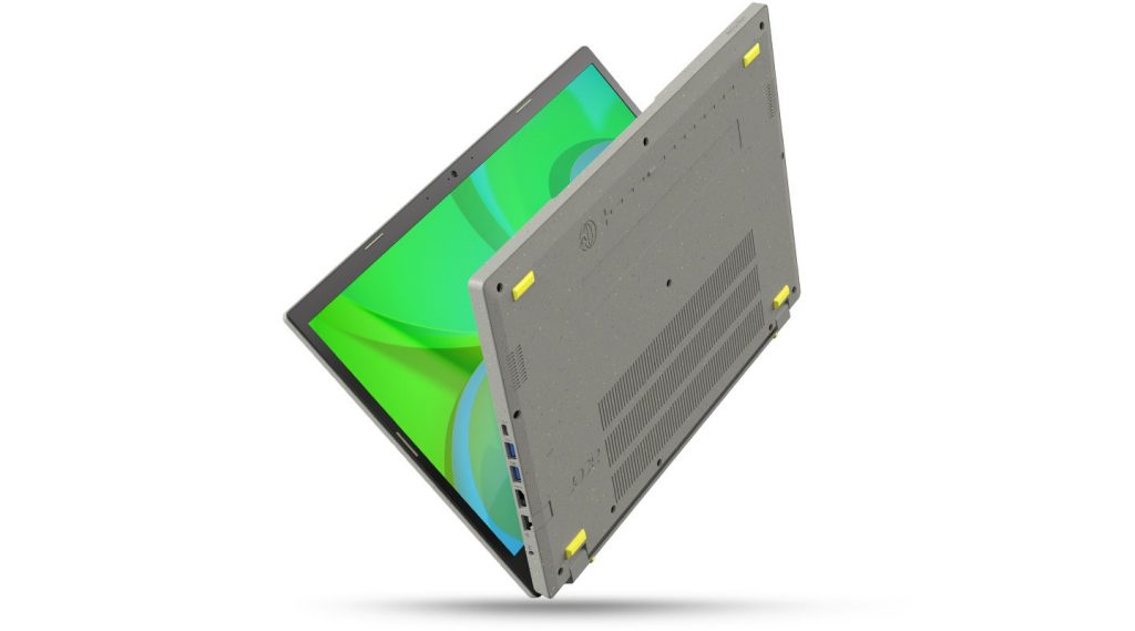 Graues halb zugeklapptes Notebook balanciert auf Kante mit grünem Display