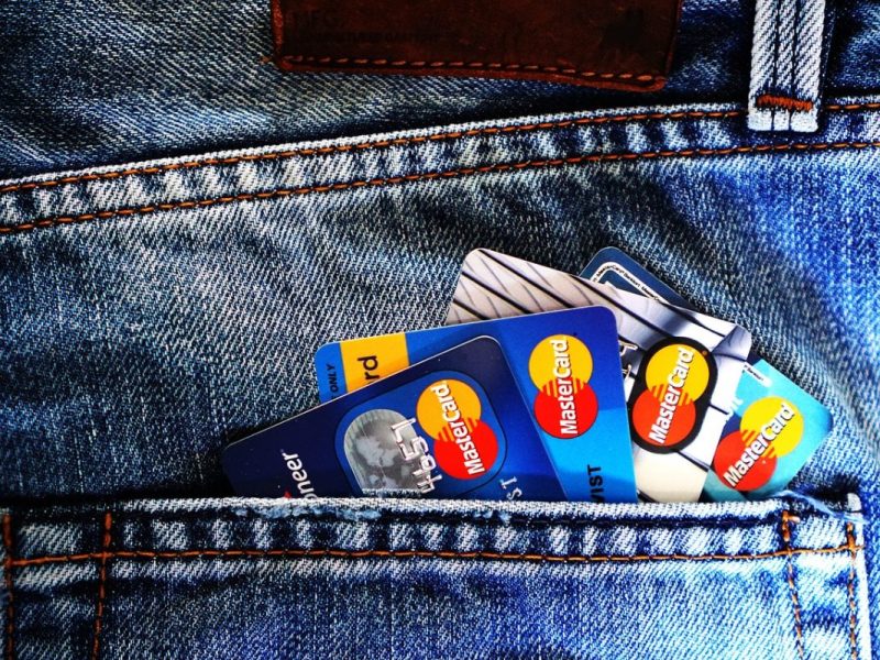 Aus einer Jeanstasche schauen 4 Kreditkarten heraus.