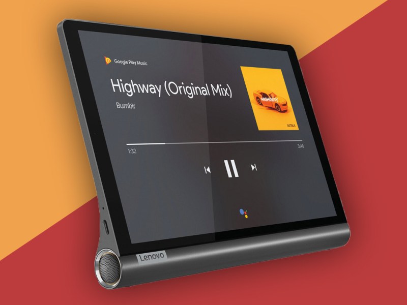 Dunkles Lenovo Tablet schräg von der Seite mit geöffnetem Musikplayer vor orange rotem Hintergrund