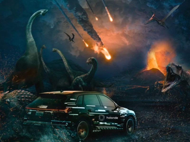 Ein Audi fährt durch einen Meteoritenhagel und wird von Dinosauriern gejagt.