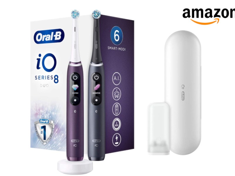 Oral-B iO zweimal in lila und in schwarz nebeneinander vor Karton, daneben weißes Etui, oben recht Amazon-Logo