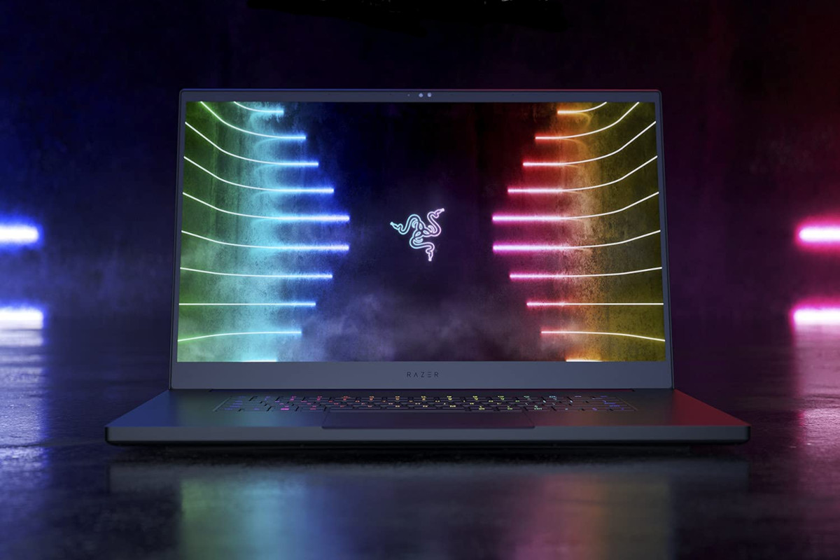 Dunkles Razer Blade Pro 17 aufgeklappt von vorne auf dunklem spiegelndem Tisch; es zeigt eine bunte Grafik mit Razer-Logo in der Mitte