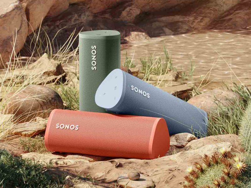 Drei Speaker von Sonos in den neuen bunten Farben liegen in einer Wüsten-Landschaft.