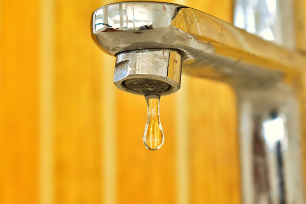 Ein Tropfen Wasser löst sich aus einem Wasserhahn.