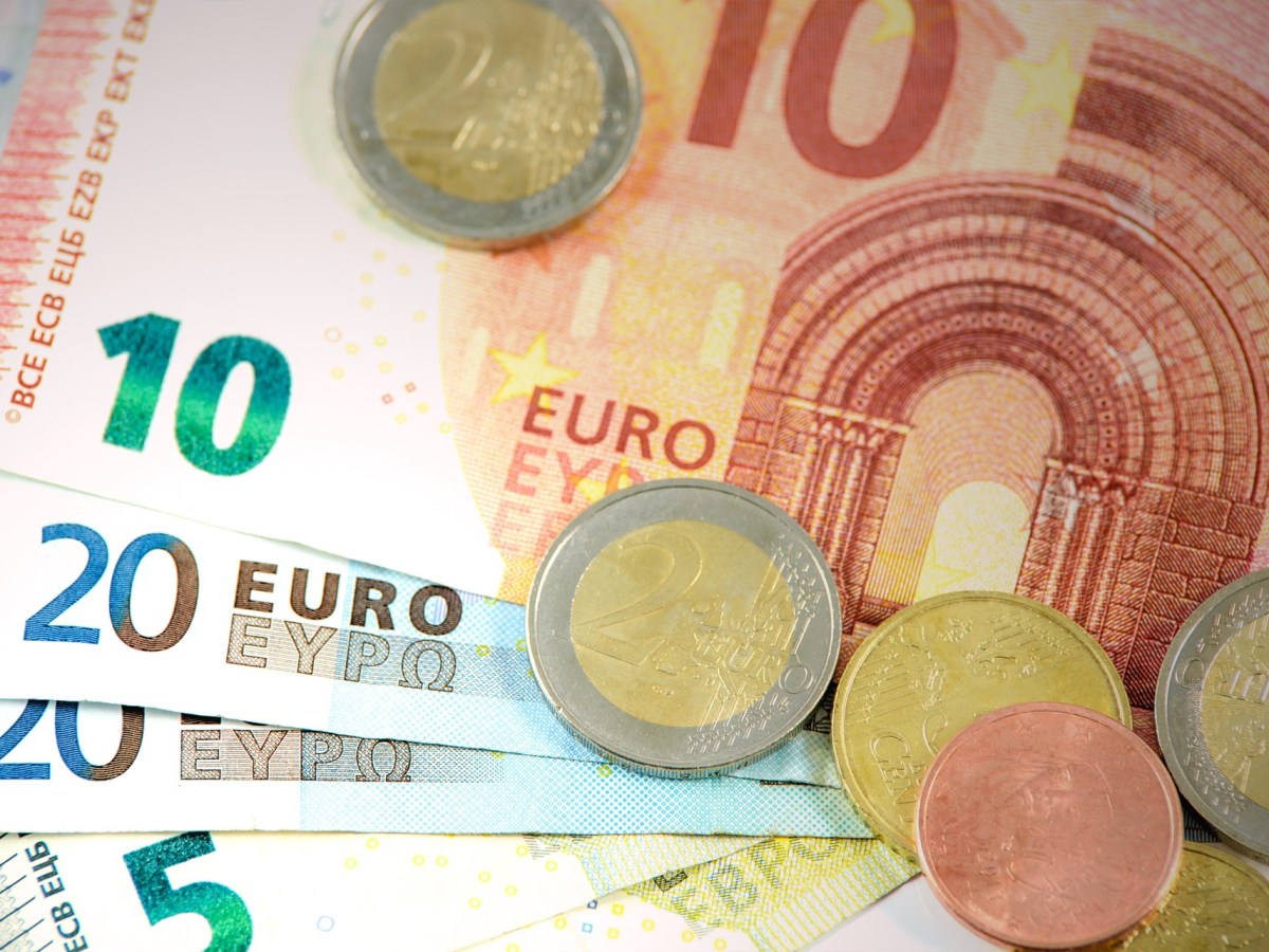 Einige Euro-Münzen liegen auf ein paar Geldscheinen.
