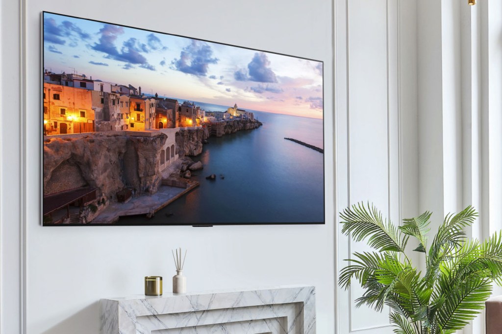 Flachbild-TV mit eingeschaltetem Bildschirm an einer Wand aufgehängt.