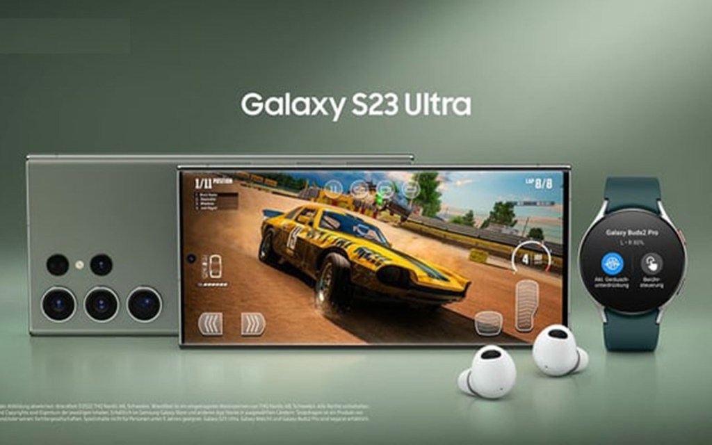 Smartphones Samsung Galaxy S23 Ultra mit Vorder- und Rückseite und zustätzlich In_Ear-Kopfhörer und Smartwatch vor grünem Hintergrund
