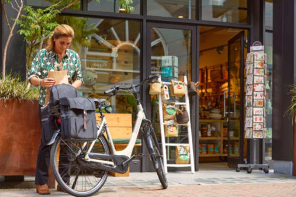 Frau belädt Fahrradtasche ihres E-Bikes von Gazelle