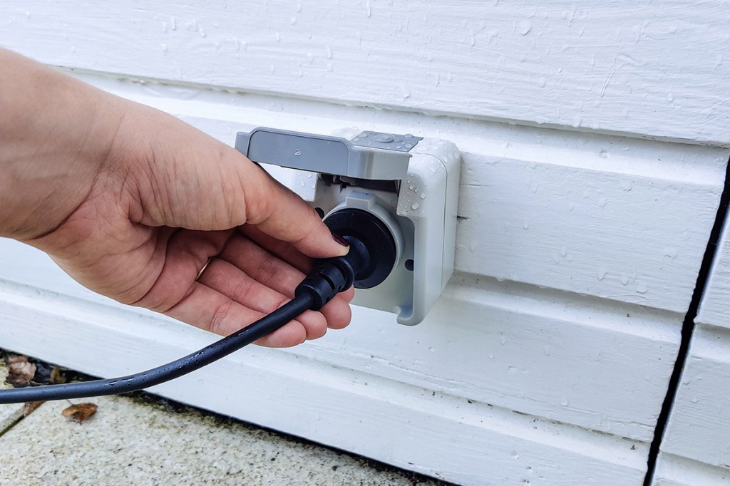 Der Schuko-Stecker des Balkonkraftwerks wird in die Außensteckdose gesteckt.