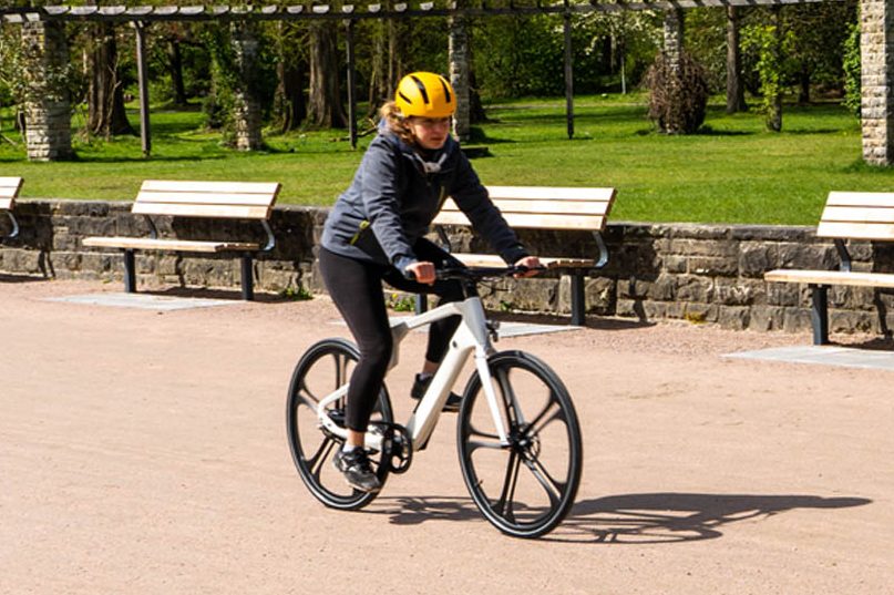 Livebild einer jungen Frau mit gelbem Helm auf dem weißen Blade One von IO Mobility.
