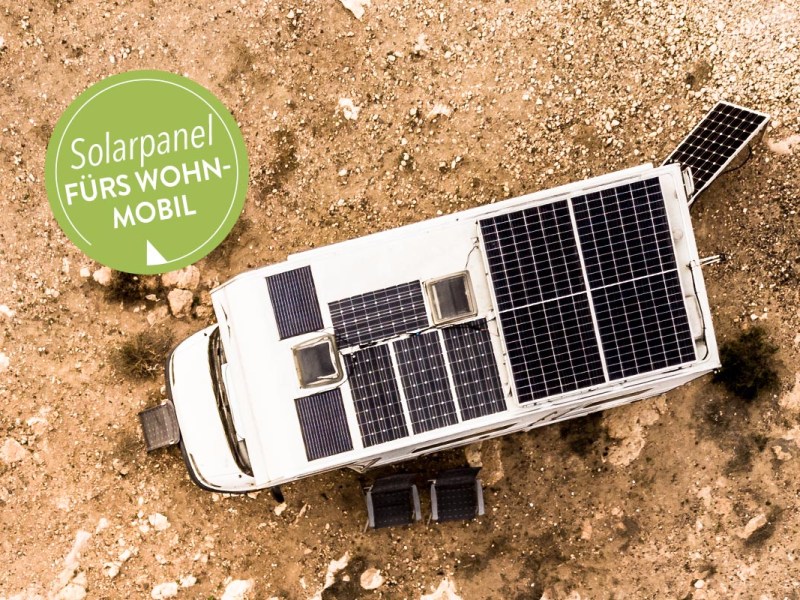 Ein Wohnmobil mit Solarpanelen auf dem Dach.