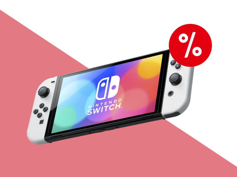 Nintendo Switch OLED in weiß als Handheld schräg von vorne schwebend auf hellrot weißem Hintergrund mit rotem Prozentzeichen oben rechts