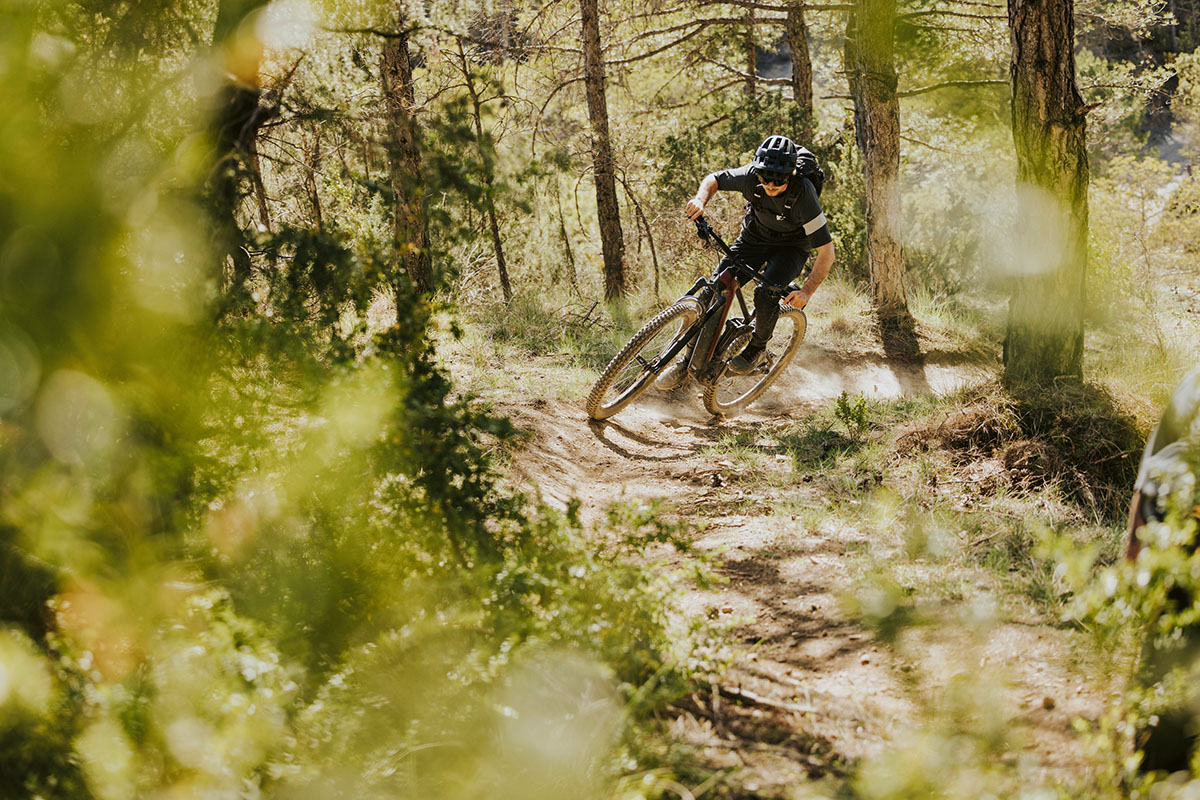 E-Mountainbike-Fahrer auf einem Waldtrail per Rad unterwegs.