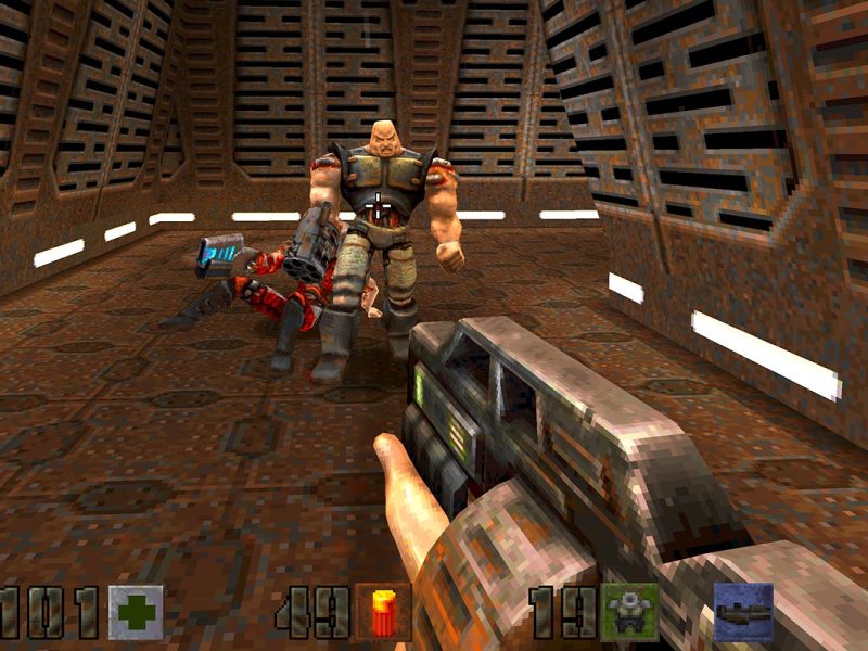 Screenshot vom Ego-Shooter Quake 2. Das Bild zeigt eine moderne Shotgun und einen Gegner, der auf das Bild zuläuft.