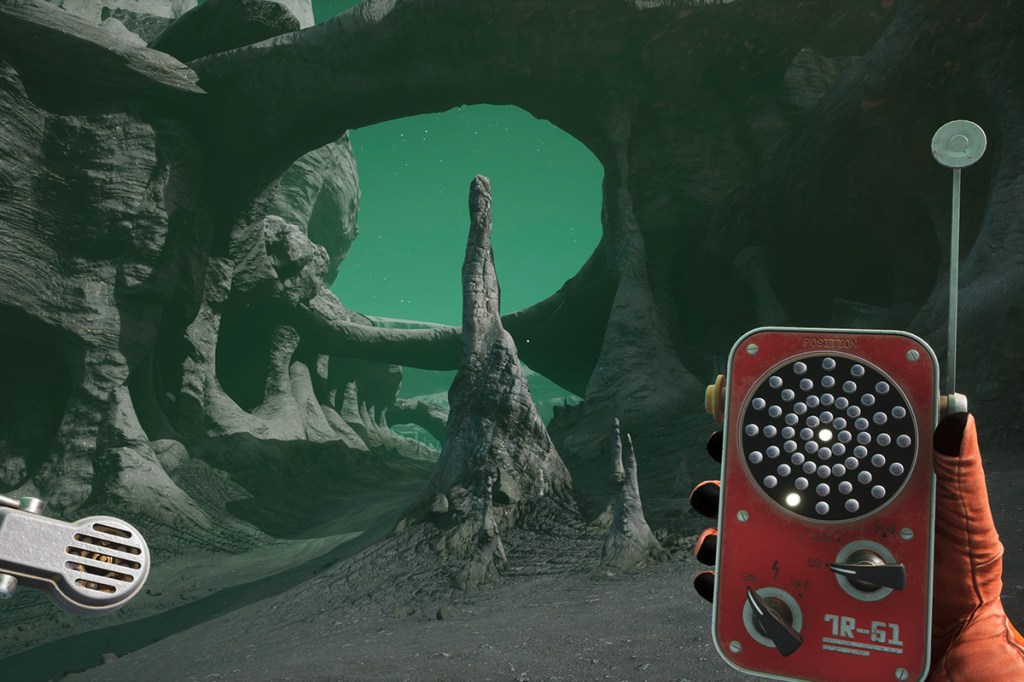 Bild eines Canyons auf einem fremden Planeten, aus dem Spiel The Invincible. Der Spieler in Ich-Perspektive hat ein seltsames Gerät in der Hand.