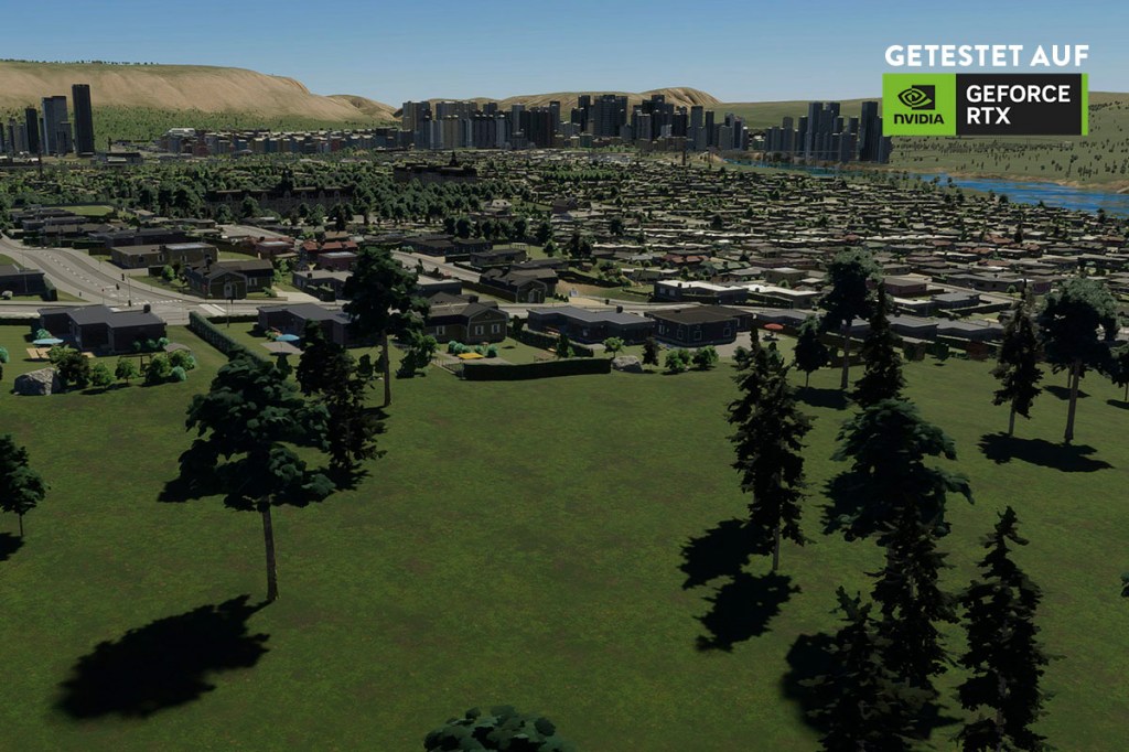 Screenshot aus dem Spiel Cities: Skylines 2. Eine Stadt bei Tag, im Hintergrund eine Skyline aus Hochhäusern.
