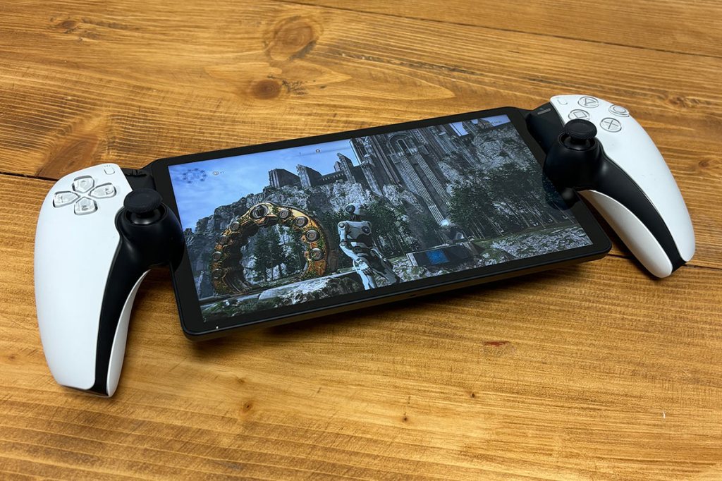 Das PS5-Handheld PlayStation Portal Remote Player, auf einem Holztisch liegend. Auf dem Bildschirm sieht man das Spiel The Talos Principle 2.