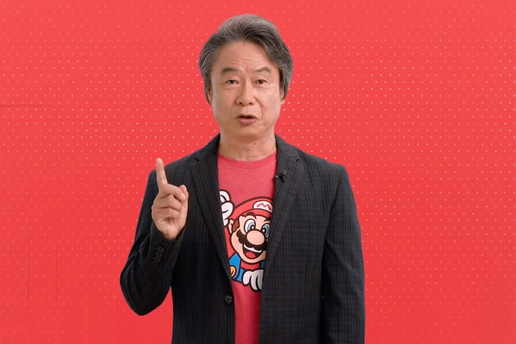 Ein Foto von Nintendo-Legende Shigeru Miyamoto vor rotem Hintergrund.