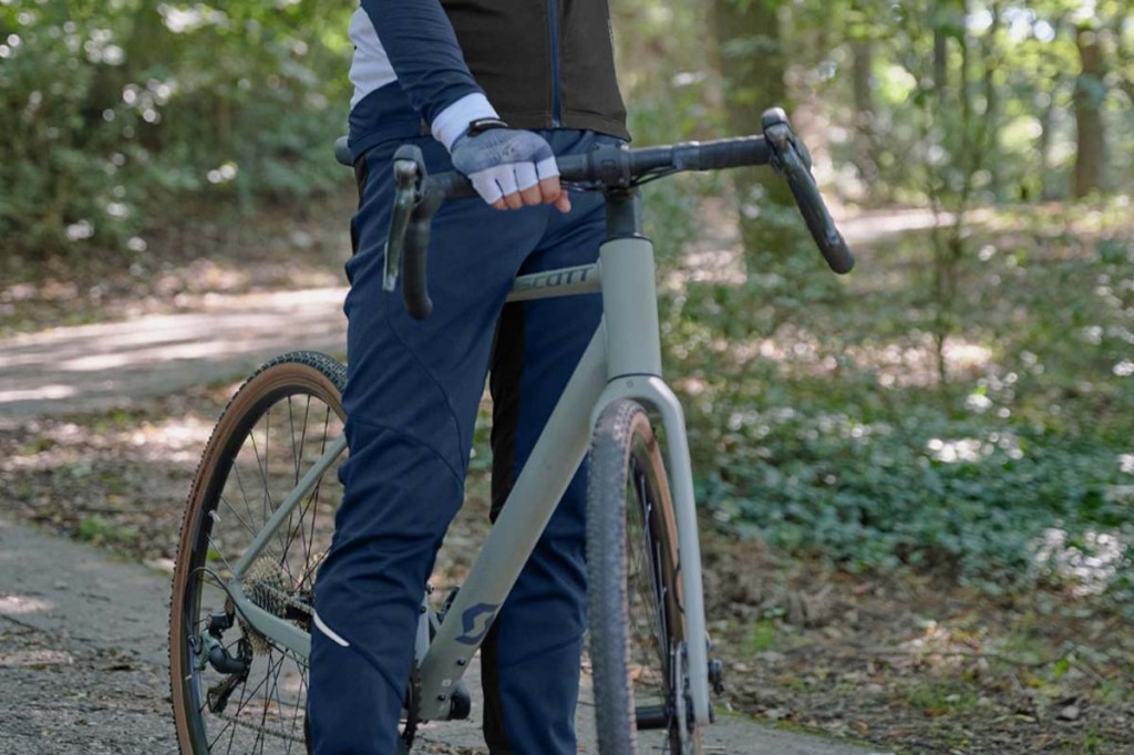 Fahrradfahrer mit seinem Fahrrad im Wald, man sieht ihn nur Bauchabwärts