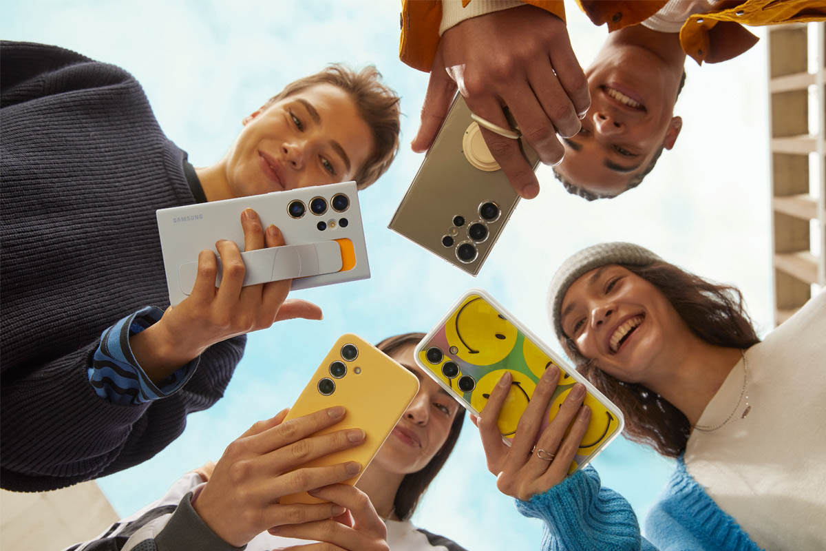 Eine Gruppe Jugendlicher schaut auf ihre S24-Smartphones