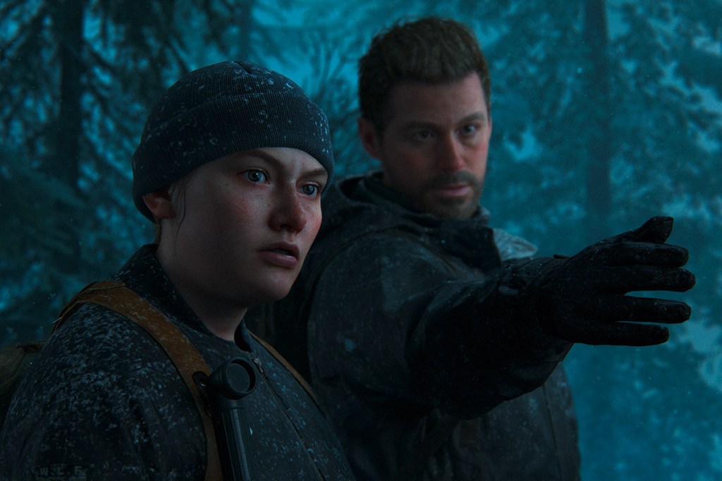 Ein Screenshot aus dem Videospiel The Last of Us Part 2 Remastered für PS5. Zu sehen sind eine Frau mit Mütze und ein Mann.