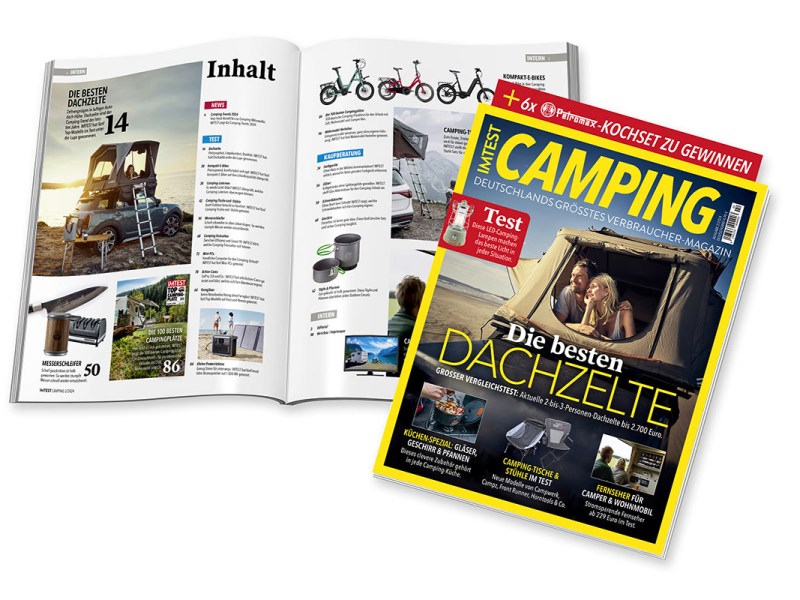 IMTEST 2/24 Camping-Magazin liegt aufgeklappt hinter einer zusammengeklappten Ausgabe.
